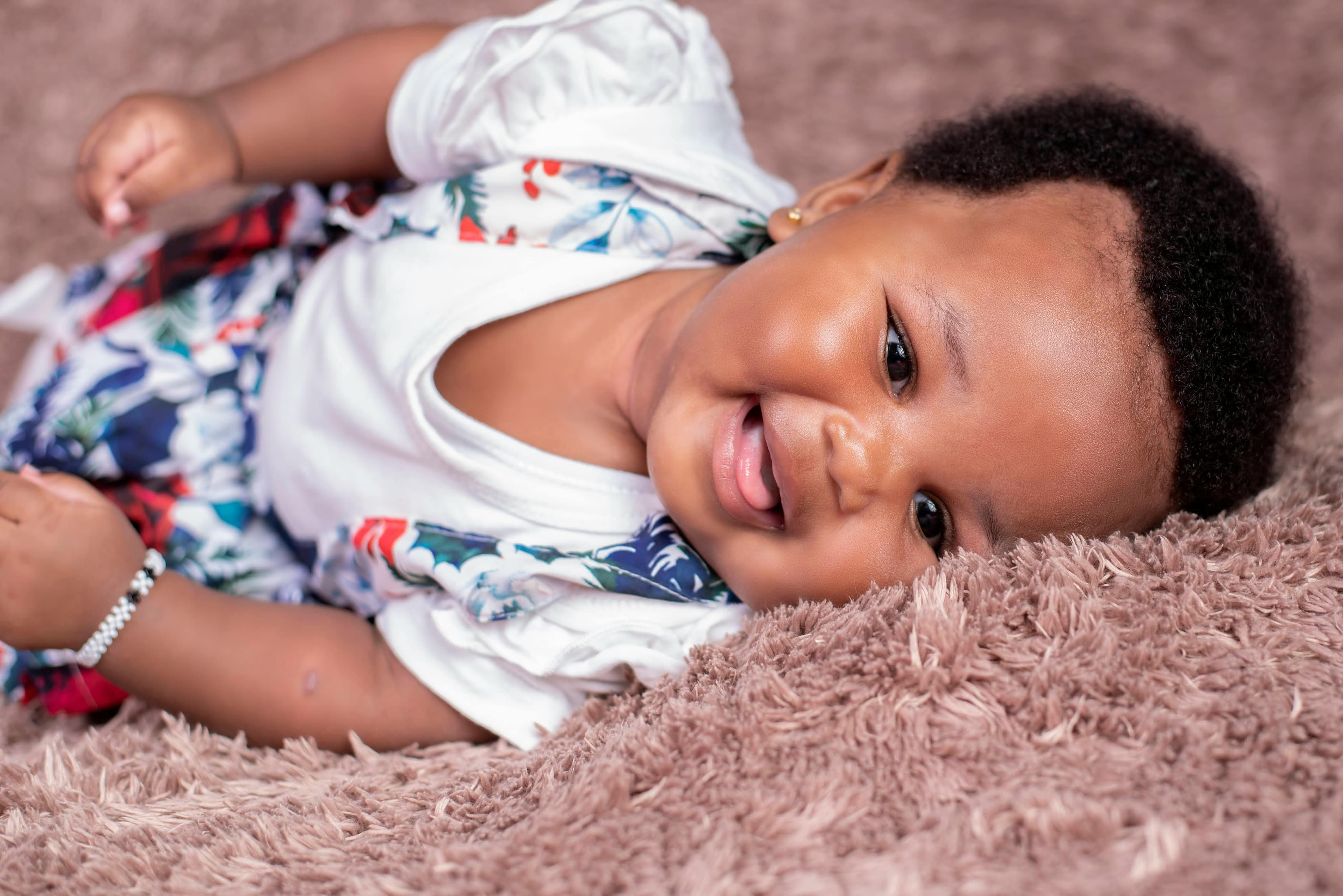 A happy baby playing with toys